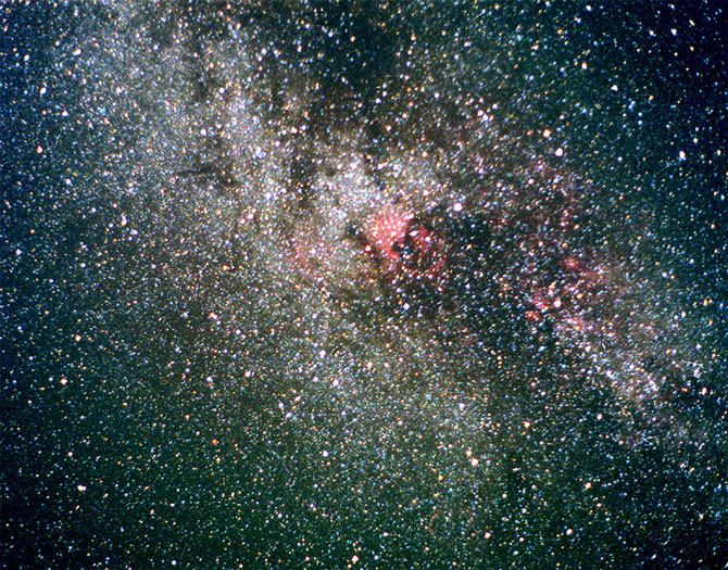 Cygnus showing off!
Paul's picture of Cynus shows up very well indeed. He is not sure of any of the details of this picture except that it was taken in Wales. In the very centre NGC 7000 is clearly visible as a redish asterism resembling north america. About 3cm to the upper right is Deneb the "tail" star of the swan!
Link-words: Star