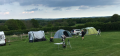 Chris_Simon_and_Mark_s_tents_plus_Daves_campervan_stuck_in_the_mud.png