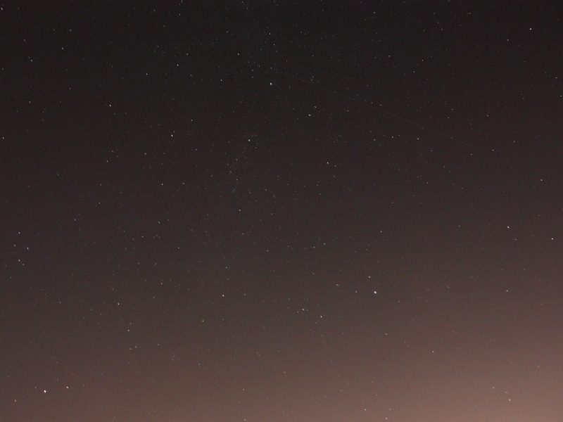 Cygnus and Lyra
Cygnus and Lyra were sinking down towards the horizon in the West. Even from the recreation ground at Otford, with London hidden by the North Downs, the light pollution is overpowering in the photo. A satellite also snuck into the shot. :)
